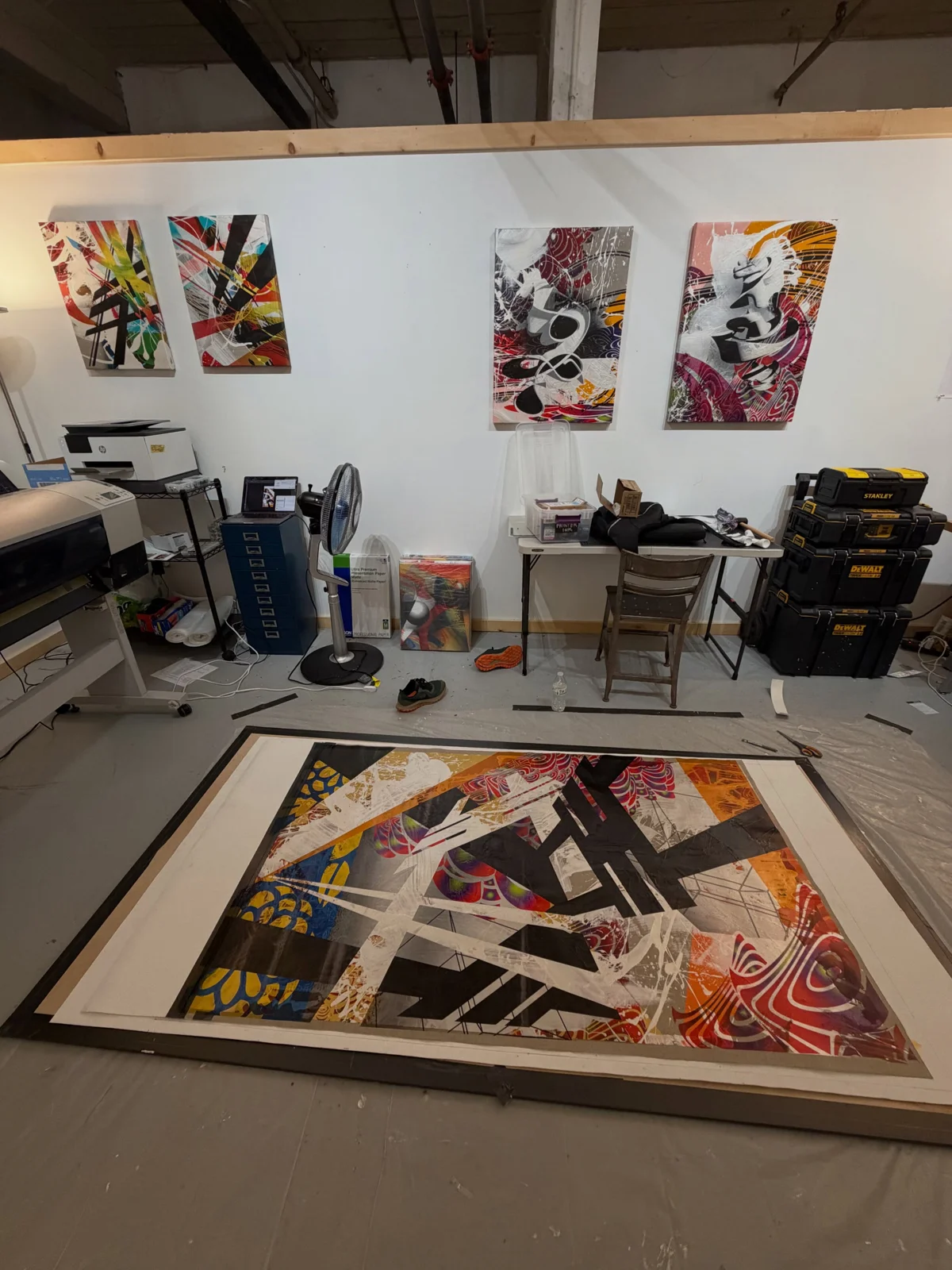 New paintings on the wall at Sage Street Mill, with a larger painting in progress on the floor.