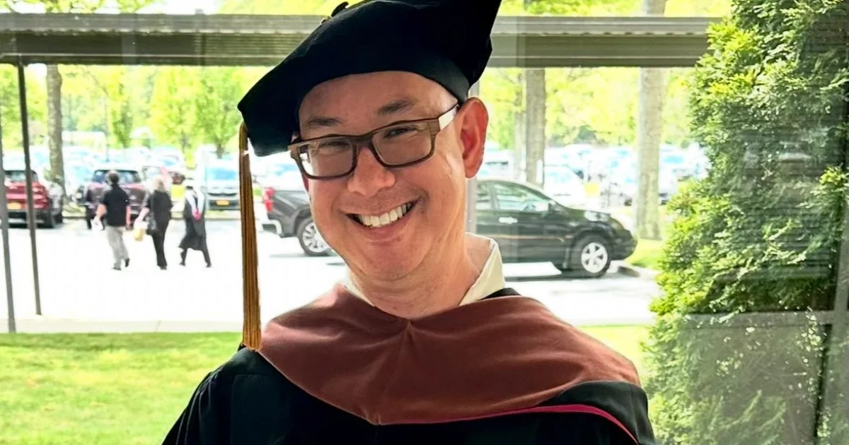 Colin Goldberg holding his Five Towns College honorary Doctor of Fine Arts diploma
